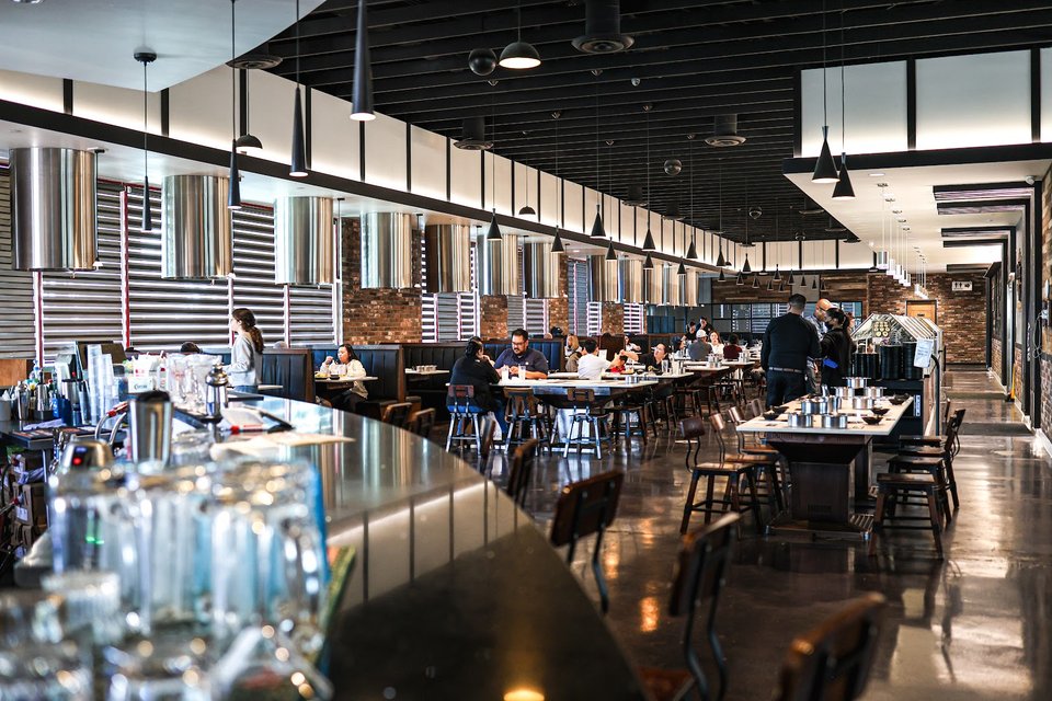 Airy contemporary restaurant interior with hot pot tables.